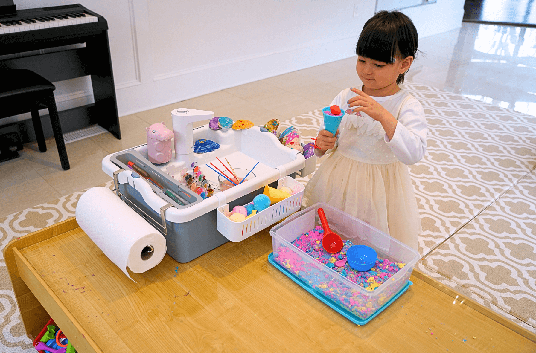 Little child doing arts and crafts in the playroom with Mighty Sink indoor and outdoor portable sink on the clean table