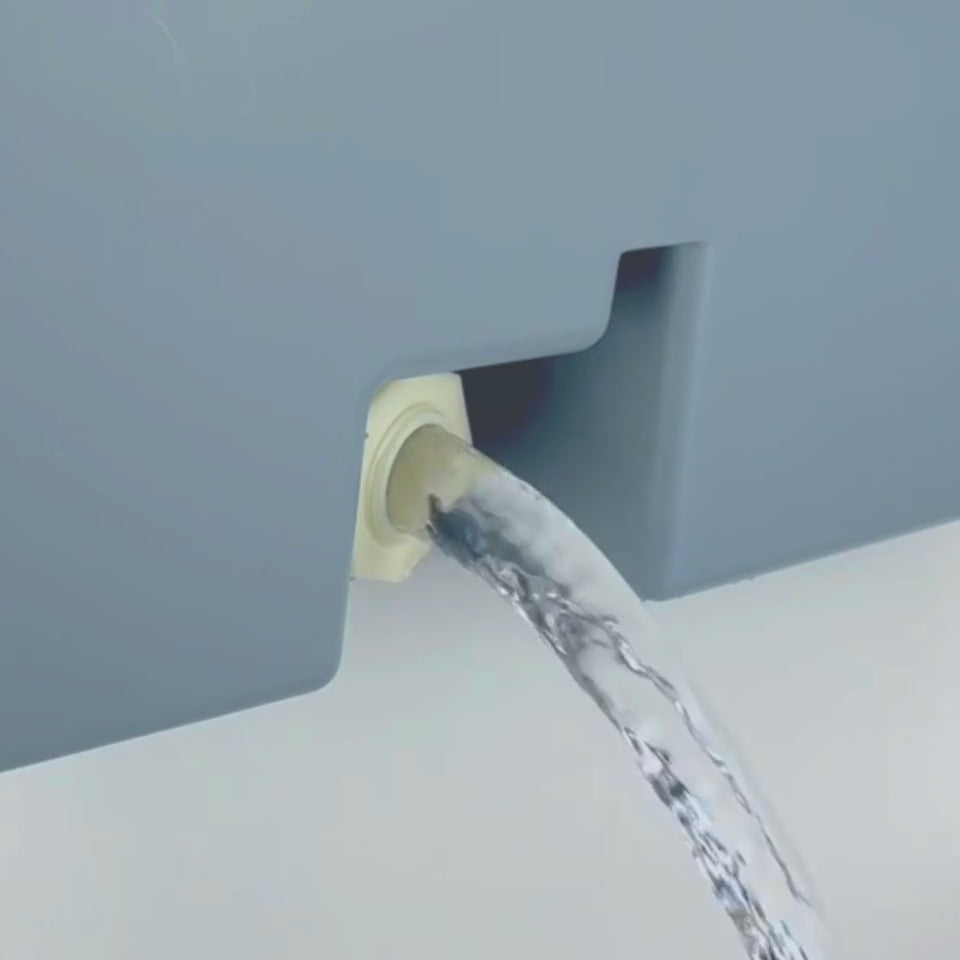 Water flowing out of Mighty Sink indoor and outdoor portable sink drain hole