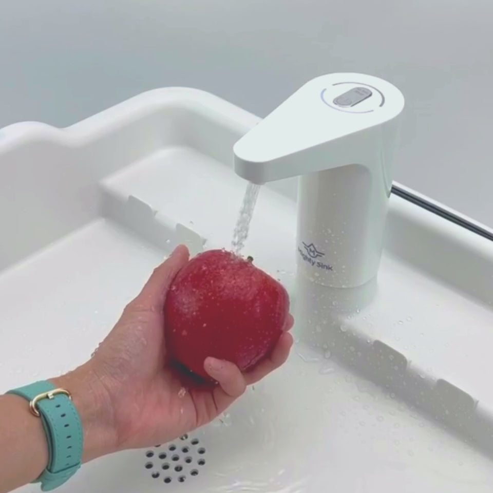 Washing red apple with Mighty Sink indoor and outdoor portable sink